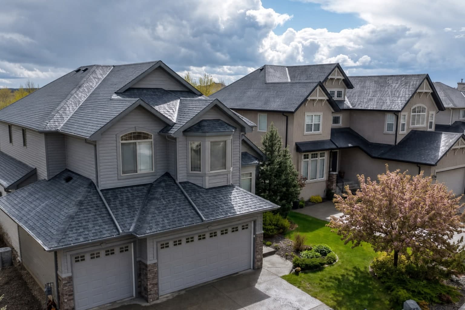 The same home re-photographed from a drone with a brand-new slate-grey shingle roof