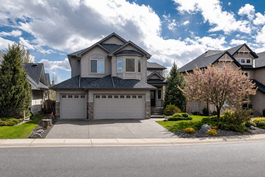 A two-story home with a three-car garage, photographed from the street