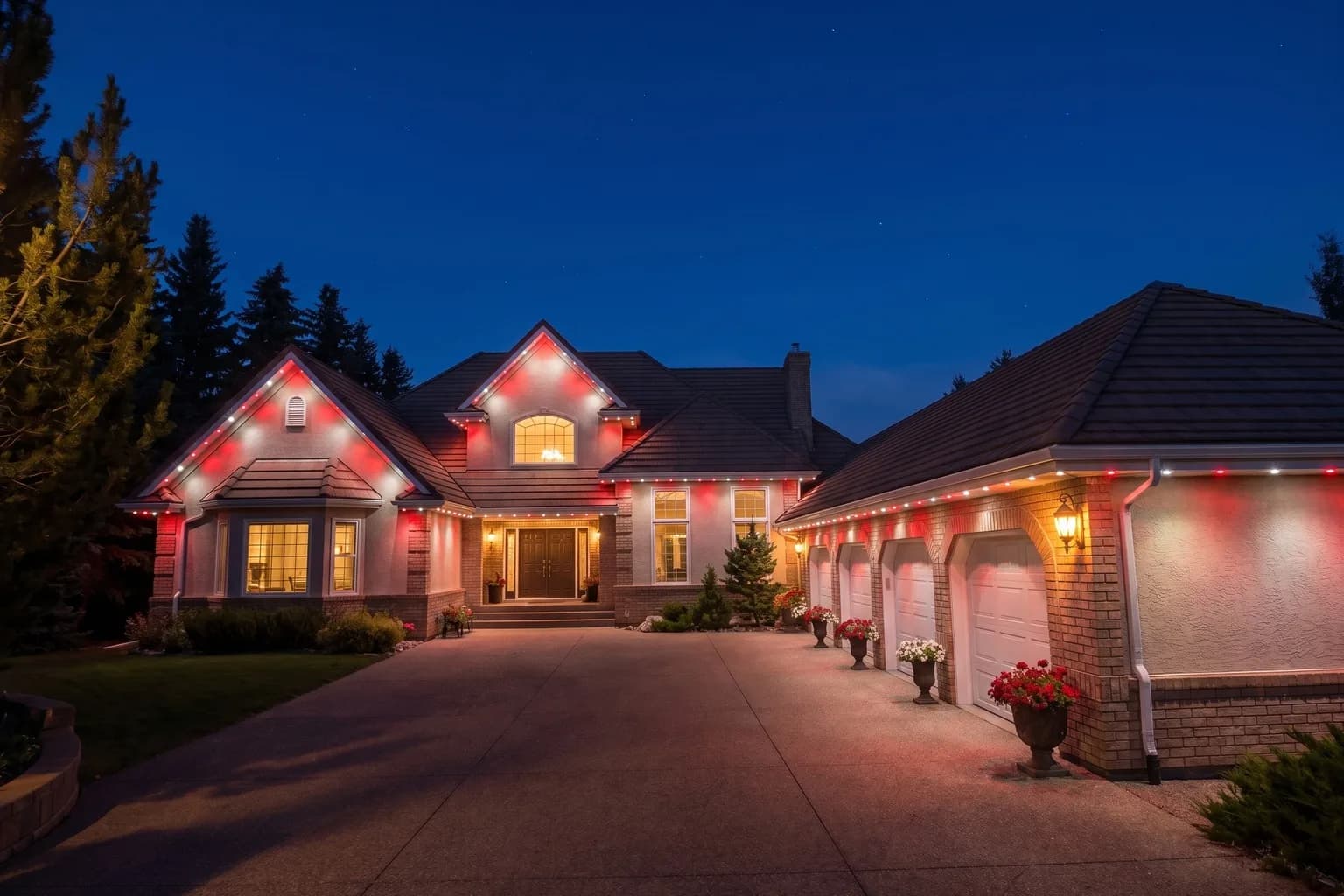The same home at dusk with alternating red and white lights along every peak and eave