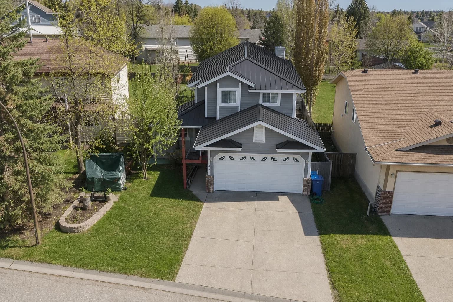 The same home with a charcoal standing-seam metal roof